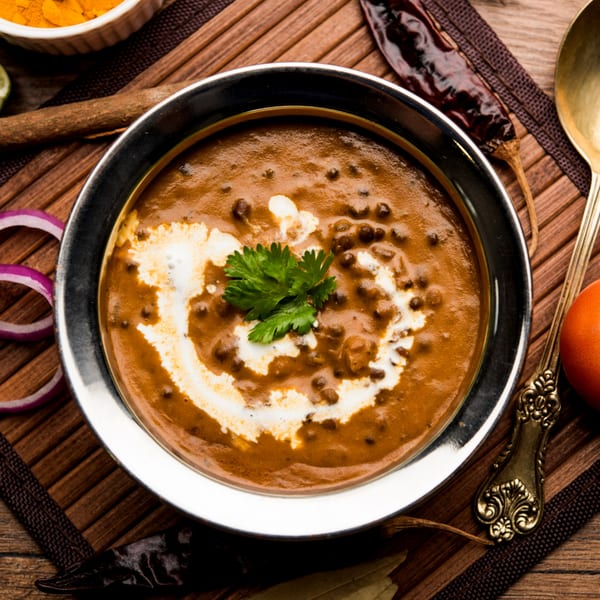 Saffron Indian Restaurant's creamy Dal Makhani, garnished with fresh cilantro and a swirl of cream.