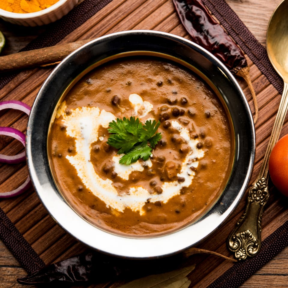 Saffron Indian Restaurant's creamy Dal Makhani, garnished with fresh cilantro and a swirl of cream.